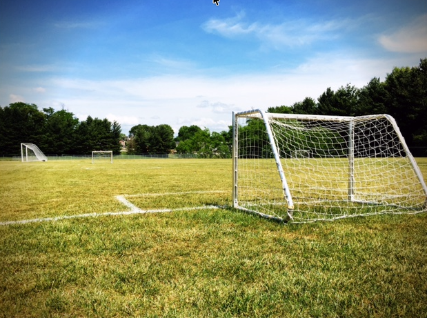 The open soccer fields behind Brainerd Junior High, with goals on green grass under a blue sky
